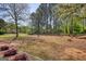 Expansive backyard featuring mature trees and an outdoor living space perfect for entertaining and relaxation at 50 Berkshire Pass, Covington, GA 30016