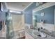 Bright bathroom featuring blue walls, a shower-tub combo, and a granite-topped vanity at 50 Berkshire Pass, Covington, GA 30016