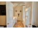 Open view into bathroom with wooden floors, double vanity, and separate tub at 50 Berkshire Pass, Covington, GA 30016