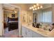 Bathroom featuring a double vanity, mirror, and a view into the main bedroom at 50 Berkshire Pass, Covington, GA 30016