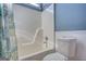Bathroom showcasing a shower-tub combo, white wainscoting, and blue accent walls at 50 Berkshire Pass, Covington, GA 30016