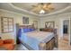 Bedroom with tray ceiling, ceiling fan, and natural light from the window at 50 Berkshire Pass, Covington, GA 30016