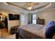 Bedroom featuring ceiling fan, large tv, access to en suite bathroom and walk-in closet at 50 Berkshire Pass, Covington, GA 30016