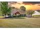 Charming two-story home with a well-maintained lawn and mature landscaping at 50 Berkshire Pass, Covington, GA 30016