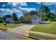 Well-manicured front yard with a two car garage and a blue sky backdrop at 50 Berkshire Pass, Covington, GA 30016