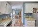Bright kitchen featuring white cabinets, granite countertops, and a view to the dining area at 50 Berkshire Pass, Covington, GA 30016
