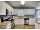 Well-lit kitchen equipped with granite countertops, stainless steel appliances, and sleek cabinetry at 50 Berkshire Pass, Covington, GA 30016