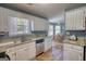 Well-lit kitchen featuring white cabinetry, stainless steel appliances, and granite countertops at 50 Berkshire Pass, Covington, GA 30016