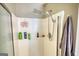 White tiled shower with a rainfall shower head and a handheld sprayer at 50 Berkshire Pass, Covington, GA 30016