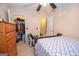 Cozy bedroom with a queen size bed and ceiling fan, complemented by an organized closet at 1346 Revelstoke Cv, Riverdale, GA 30296