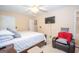 Comfortable bedroom featuring a sizable bed, a television, and a cozy armchair with soft pillows at 1346 Revelstoke Cv, Riverdale, GA 30296