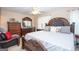 Spacious bedroom with a large bed, wooden furniture, and ample natural light from the window at 1346 Revelstoke Cv, Riverdale, GA 30296