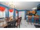 Vibrant dining room with a large table, chandelier, and an adjacent kitchen at 1346 Revelstoke Cv, Riverdale, GA 30296