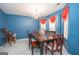 Bright dining area featuring modern colors, a large table and decorative window treatments at 1346 Revelstoke Cv, Riverdale, GA 30296