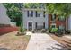 Inviting townhome with a well-kept lawn, complemented by decorative plants and a concrete driveway at 1346 Revelstoke Cv, Riverdale, GA 30296