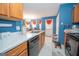 A cozy kitchen area flows into a dining space, complete with wood cabinets and stainless steel appliances at 1346 Revelstoke Cv, Riverdale, GA 30296