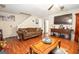 Spacious living room showcasing hardwood floors, a ceiling fan, and lots of comfortable seating at 1346 Revelstoke Cv, Riverdale, GA 30296