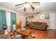 Comfortable living area with gleaming hardwood floors, a ceiling fan, and comfortable furniture at 1346 Revelstoke Cv, Riverdale, GA 30296
