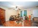 Inviting living space features hardwood floors, a ceiling fan, and cozy seating at 1346 Revelstoke Cv, Riverdale, GA 30296