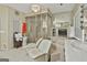 Bright bathroom featuring a corner bathtub and shower with two white chairs at 226 Long Island Dr, Whitesburg, GA 30185