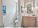 Bathroom featuring an oval mirror with vanity lights and updated vanity with marble countertop at 226 Long Island Dr, Whitesburg, GA 30185