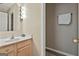 Bathroom features a white marbled countertop with tan cabinets, a mirror with vanity lighting at 226 Long Island Dr, Whitesburg, GA 30185