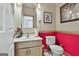 Cozy bathroom featuring marble countertops, decorative art, and bright red accent wall at 226 Long Island Dr, Whitesburg, GA 30185