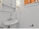 Bright bathroom featuring white cabinets with chrome pulls, light sconces, and a white sink at 226 Long Island Dr, Whitesburg, GA 30185