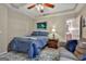 Cozy bedroom with tray ceilings, fan, and a glimpse of the adjoining bathroom at 226 Long Island Dr, Whitesburg, GA 30185