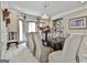 Formal dining room with a chandelier, large windows, and a long table with seating for twelve at 226 Long Island Dr, Whitesburg, GA 30185