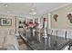 Dining room with long table and decorative chandelier at 226 Long Island Dr, Whitesburg, GA 30185
