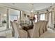 Elegant dining room with a chandelier and a long table with seating for twelve at 226 Long Island Dr, Whitesburg, GA 30185