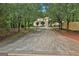 Long driveway leading to a beautiful home, surrounded by lush greenery and mature trees at 226 Long Island Dr, Whitesburg, GA 30185