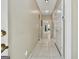 Neutral hallway with tiled flooring and multiple doors leading to various rooms at 226 Long Island Dr, Whitesburg, GA 30185