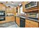 Charming kitchen with wood cabinets, stone countertops, and modern appliances at 226 Long Island Dr, Whitesburg, GA 30185