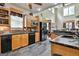 Well-equipped kitchen featuring stone countertops, stainless steel appliances, and dark slate flooring at 226 Long Island Dr, Whitesburg, GA 30185