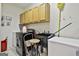 Functional laundry room with black appliances, a utility sink, and ample cabinet storage at 226 Long Island Dr, Whitesburg, GA 30185