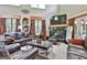 Inviting living room boasts a fireplace, large windows, and comfortable brown leather seating at 226 Long Island Dr, Whitesburg, GA 30185