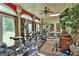 Bright sun room with an exercise area, tile floor, ceiling fan, and large windows at 226 Long Island Dr, Whitesburg, GA 30185
