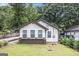 Charming bungalow featuring a well-manicured lawn and three windows that enhance the facade at 523 Mount Zion, Hapeville, GA 30354