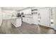 Modern kitchen with stainless appliances, granite countertops, and white cabinets, open to living area at 523 Mount Zion, Hapeville, GA 30354