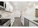 Bright kitchen featuring granite countertops, modern appliances, and white cabinetry with an open floor plan at 523 Mount Zion, Hapeville, GA 30354