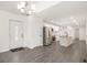 Open-concept living area with updated floors flowing into the kitchen, featuring a stainless refrigerator at 523 Mount Zion, Hapeville, GA 30354