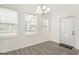 Inviting living room with new flooring, a chandelier, and ample natural light streaming through the multiple windows at 523 Mount Zion, Hapeville, GA 30354