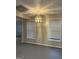 Basement area with gray painted concrete floor, windows and modern lighting at 2360 Barrington Trace Sw Cir, South Fulton, GA 30331