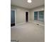 Spacious bedroom with neutral carpet, baseboard trim, and natural light from the window at 2360 Barrington Trace Sw Cir, South Fulton, GA 30331