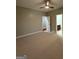 Large bedroom with neutral carpet, ceiling fan and views into the ensuite bathroom at 2360 Barrington Trace Sw Cir, South Fulton, GA 30331
