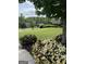Green lawn with bushes and trees in front of a house in a neighborhood at 2360 Barrington Trace Sw Cir, South Fulton, GA 30331