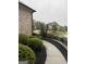 Well landscaped yard with a sidewalk, bushes, and grass at 2360 Barrington Trace Sw Cir, South Fulton, GA 30331
