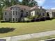 Beautiful two-story home boasting well-manicured lawn, brick facade, and lush landscaping at 2360 Barrington Trace Sw Cir, South Fulton, GA 30331